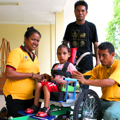 Photo of Timor-Leste team working with a child wheelchair user