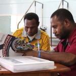 Two trainees in PNG learn their training material!
