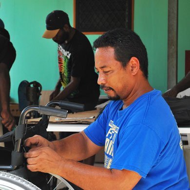 TRS technical trainer Tebakaro demonstrating the adjustment of a backrest during the basic wheelchair training in Vanuatu.