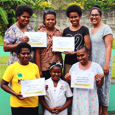Vanuatu: A group of 7 women of different ages proudly hold their certificates and smile at the camera.