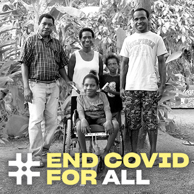 A young girl using a wheelchair sits surrounded by another child, a woman and two men. They smile for the camera. #EndCovidForAll is written along the bottom.