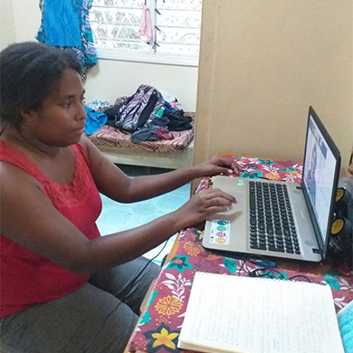 Sharon Juvia, Orthotist, working on laptop with Motivation Australia DFC online training.
