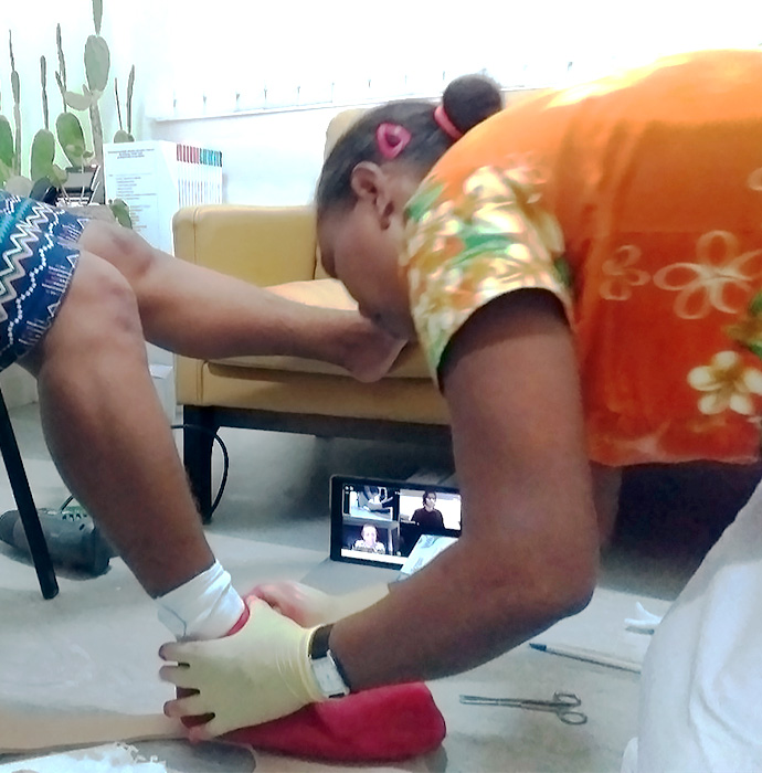Participant makes a cast shoe in front a laptop showing a video conference in progress.