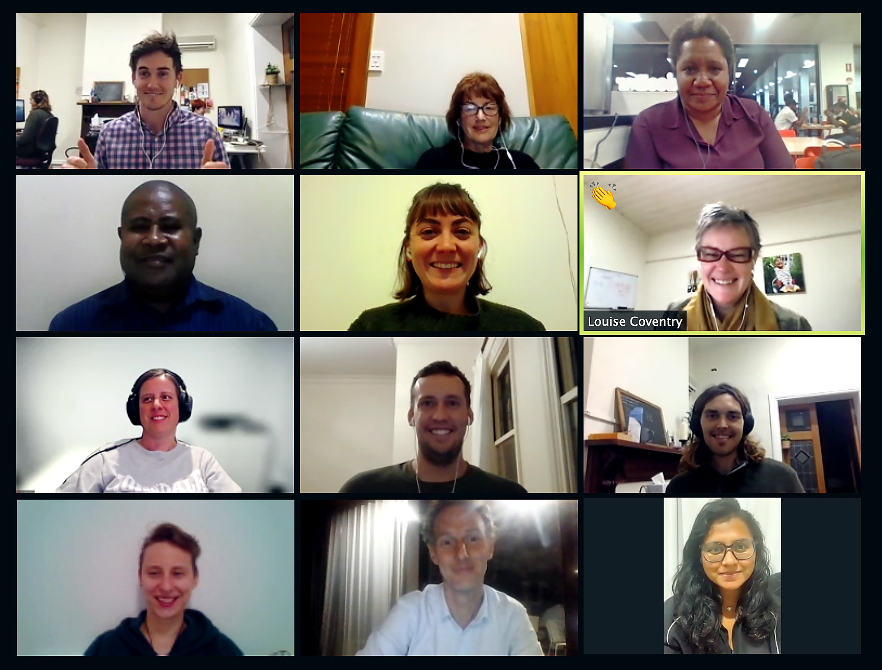 12 people on a video call smiling at the camera.