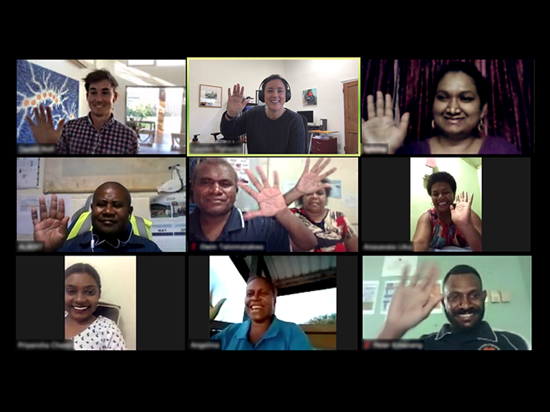 A group of 10 people on a video call smile and wave at each other.